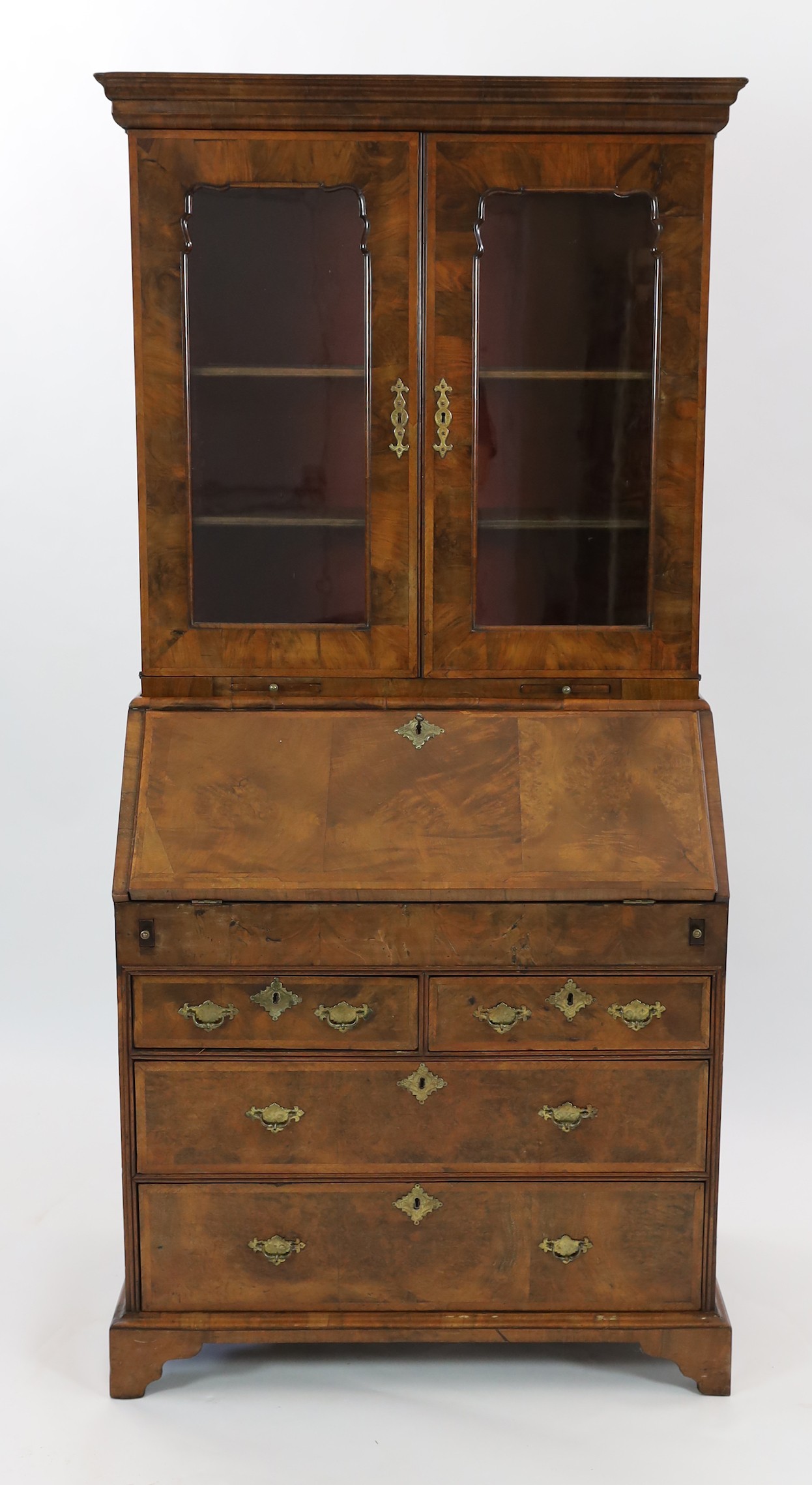 An early 18th century feather banded walnut bureau bookcase, width 96cm depth 57cm height 198cm